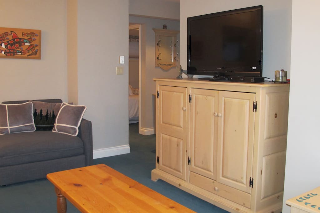 TV with playstation and comfy chair.