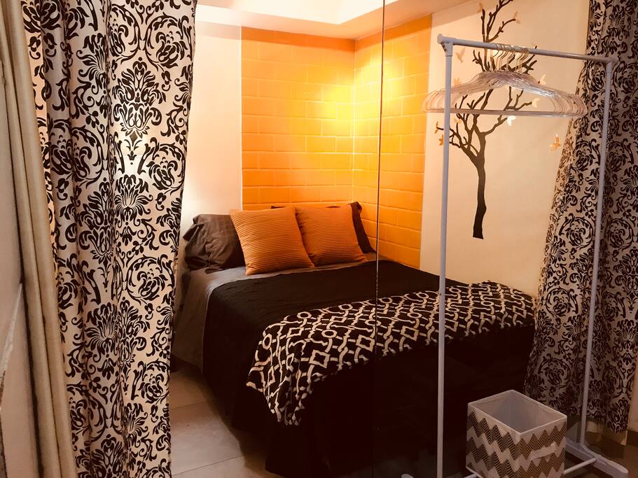 Full size bed with space underneath, and hanging rack for clothes!