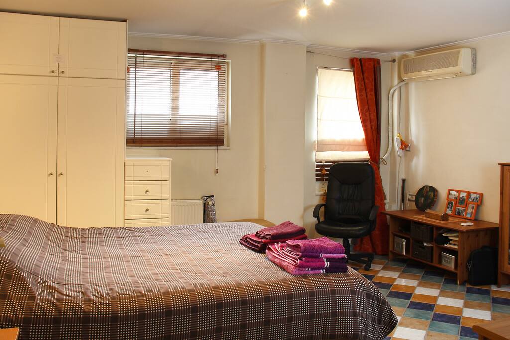 Bedroom with comfortable fluffy bed. Apartment is on the ground floor of a quiet street that makes it ideal for a good night’s sleep!