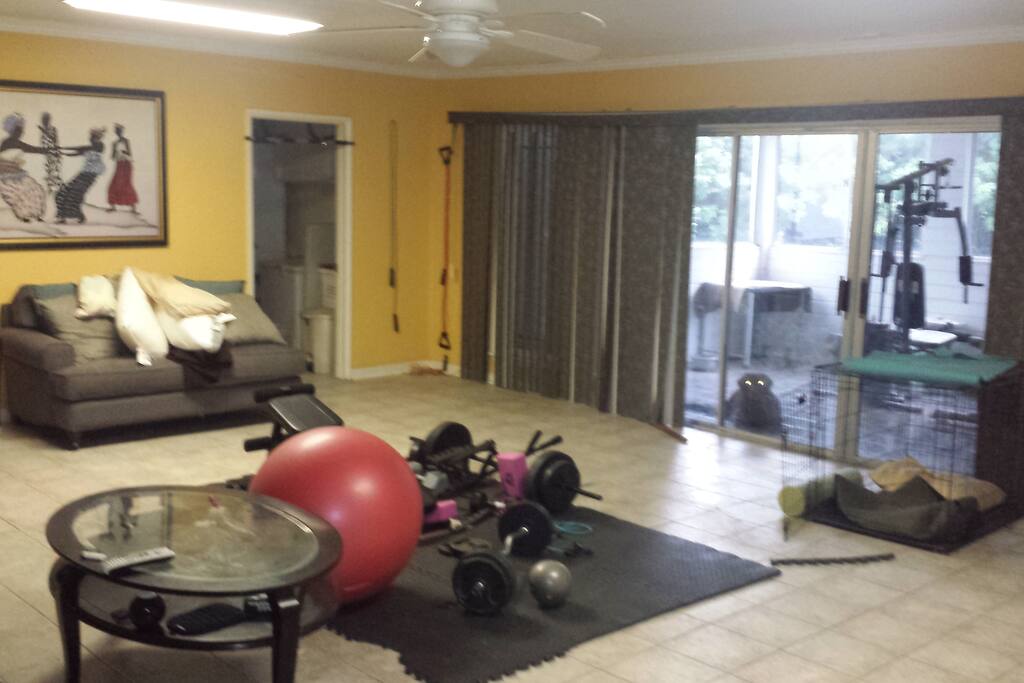 Family room with workout equipment and 55" tv with cable.
