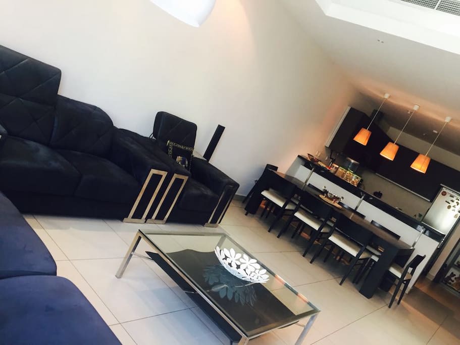 Living Room: Sofa Set with 8 Seater dining table and T.V with Music System.