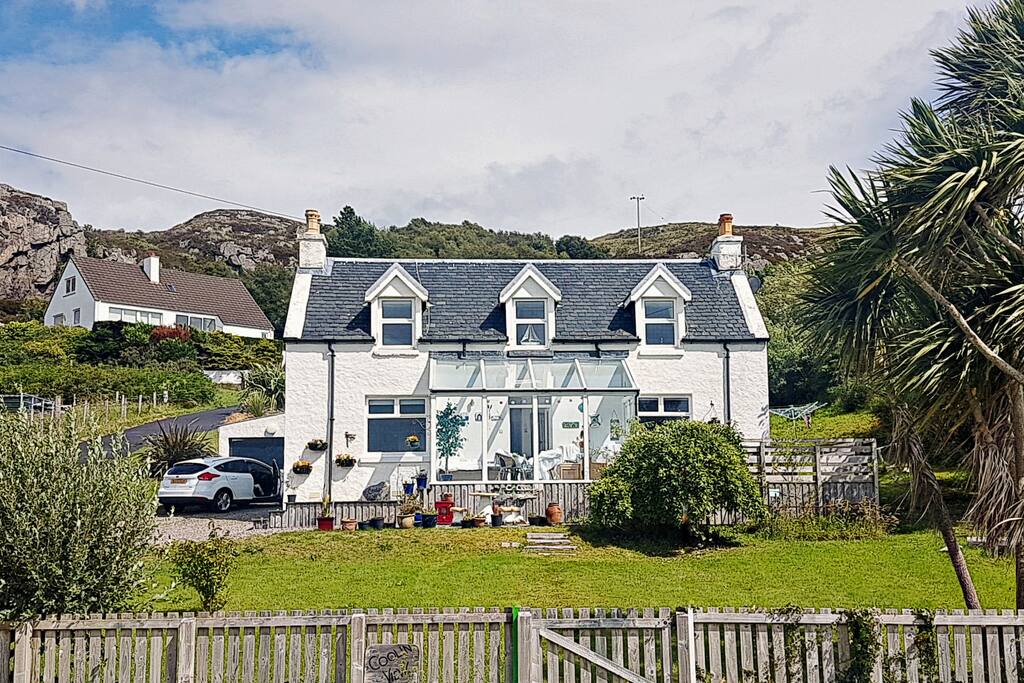 The house and conservatory. Every window is forward-facing and when you first see the views you will understand why. Almost 180 degrees of stunning Highland scenery.