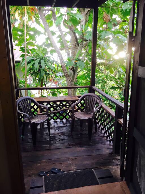 Small deck with peekaboo of the ocean behind the community space.