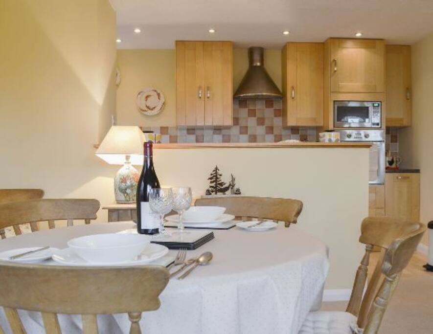 Dining area with open plan kitchen behind