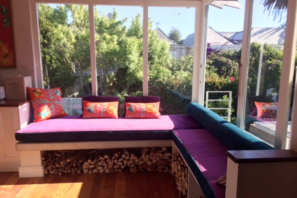 Relax on the daybed above the pool, looking at Table Mountain