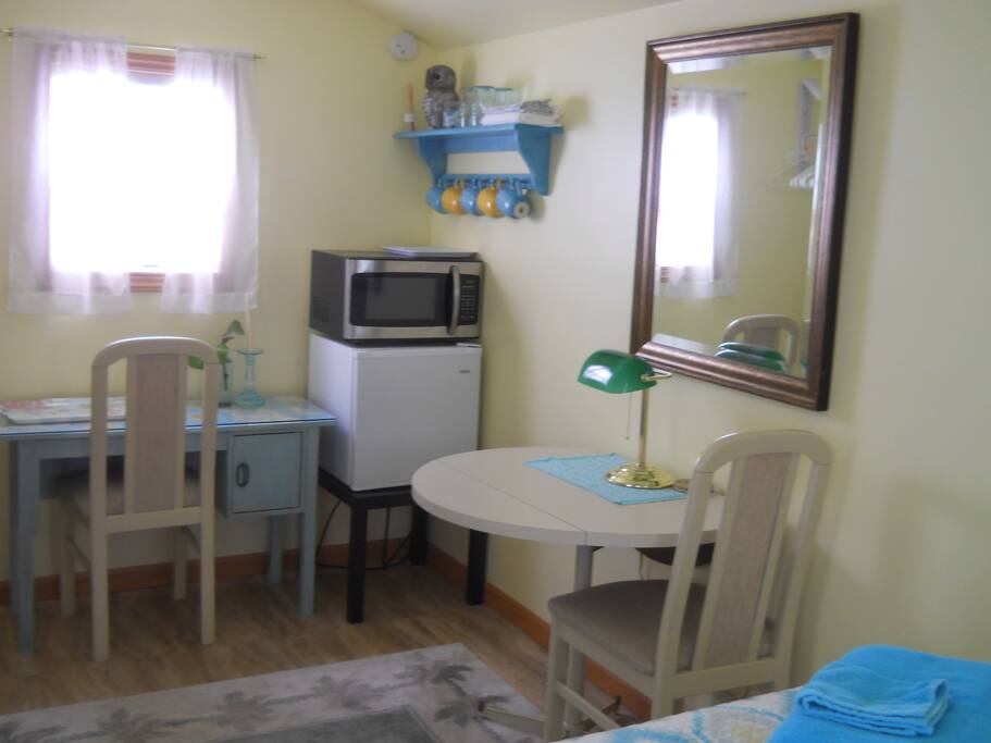 Mini fridge, microwave oven, table, desk, two chairs