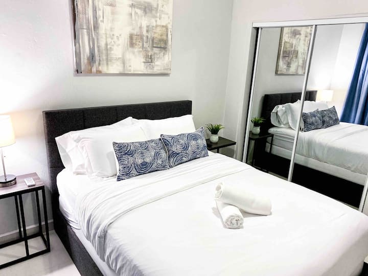 Enjoy a comfortable, air-conditioned bedroom with a queen bed, elegant décor, TV, and ample closet space. Perfect for a restful stay.