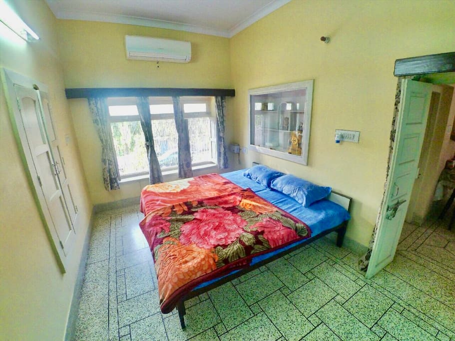 Chip (Room 2: AC): A relaxing cream color painted room comes with AC newly fitted AC not notch O'General Air conditioner. This room sports a huge entire wall set window with a beautiful garden view. The room also has mat white colored royal wooden word.