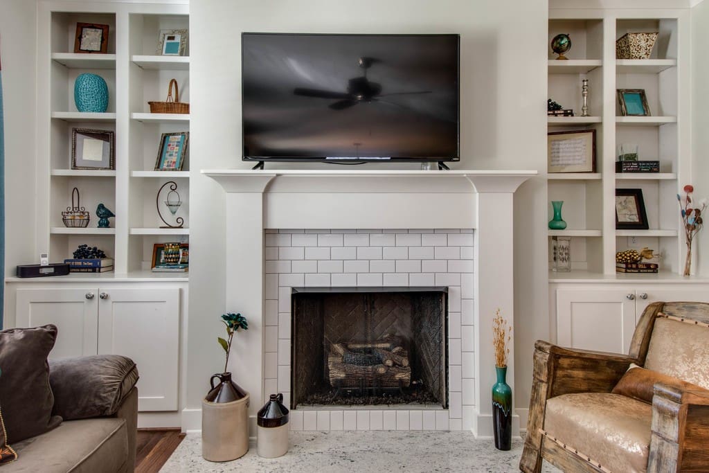 Decorative fireplace and flat-screen TV in the living area.