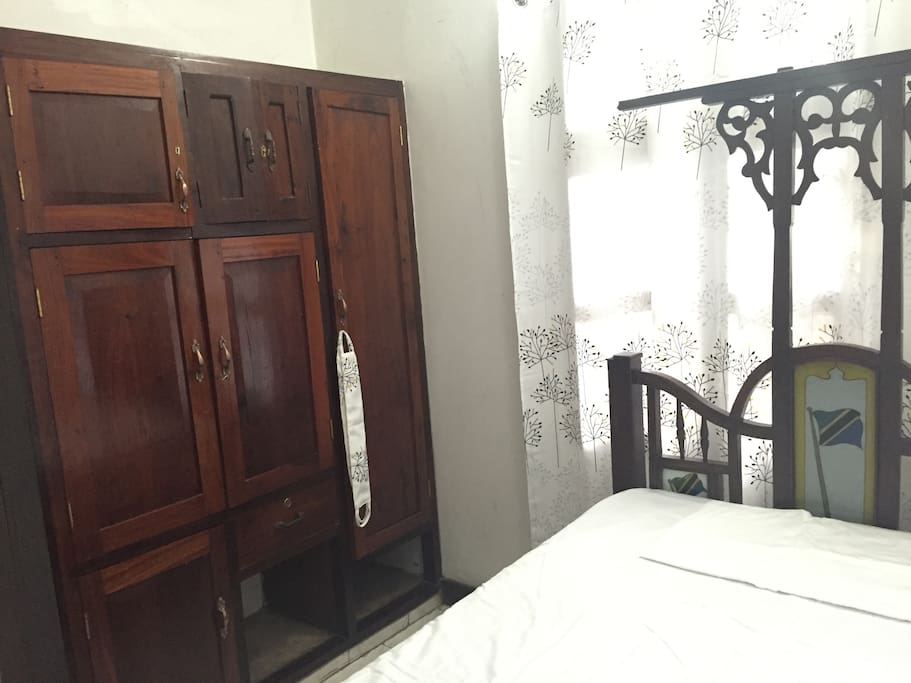 The room features a traditional Zanzibari style bed.