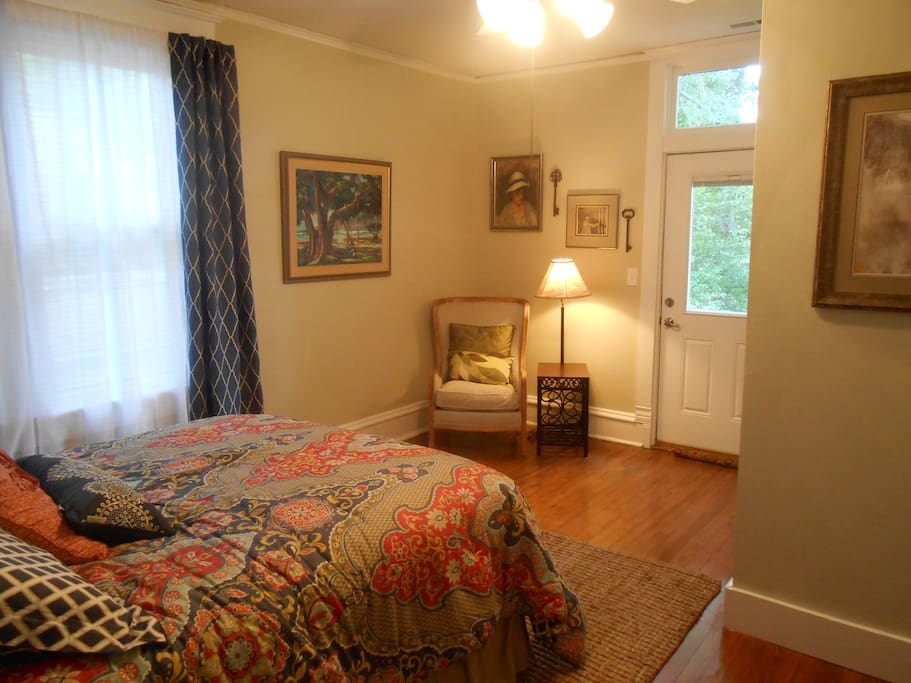 Bedroom with queen bed and small sitting area