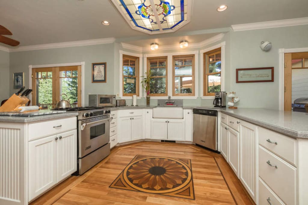 The well-outfitted kitchen has custom wood inlay in the floor and a marble cutting board and rolling pin.