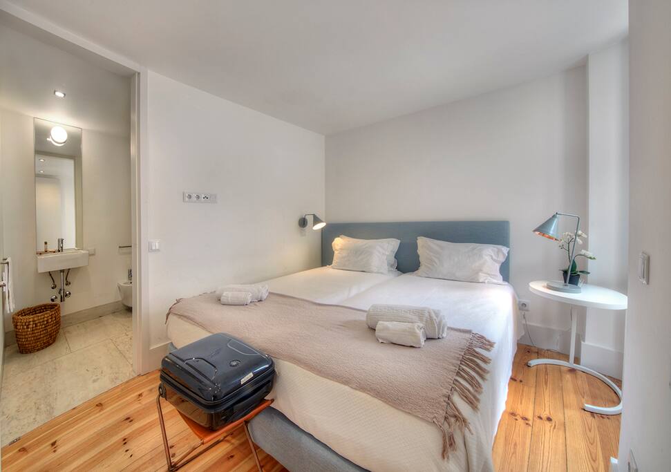 Our Bedroom, with a big window and the bathroom enclosed.