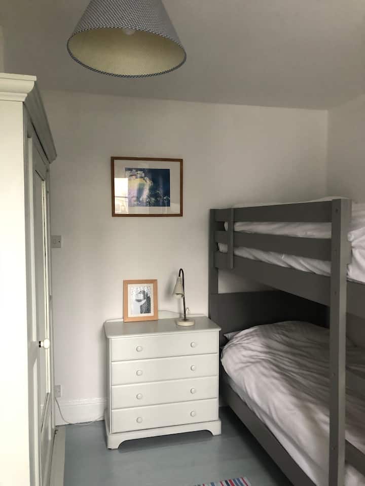 Bunk bed room 
New grey modern bunk beds 
Painted wood panelled walls 