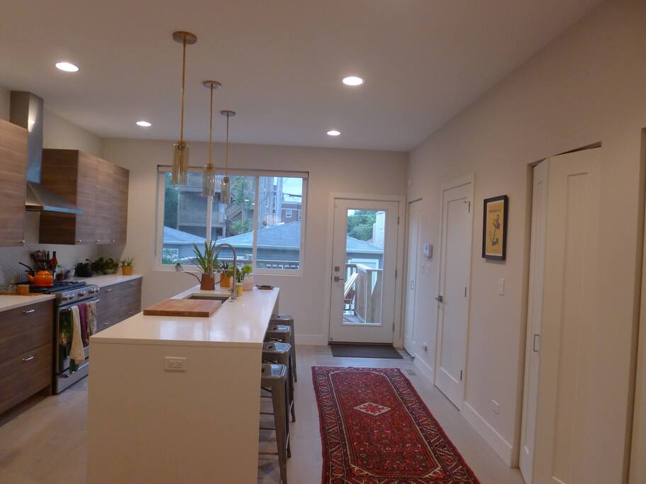 View facing the back of the house and deck. Bathroom and closets along the wall on the right.