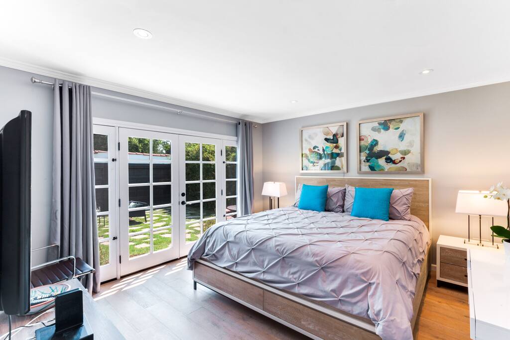 Downstairs bedroom with California King Bed, Sony 65" Tv. Bathroom