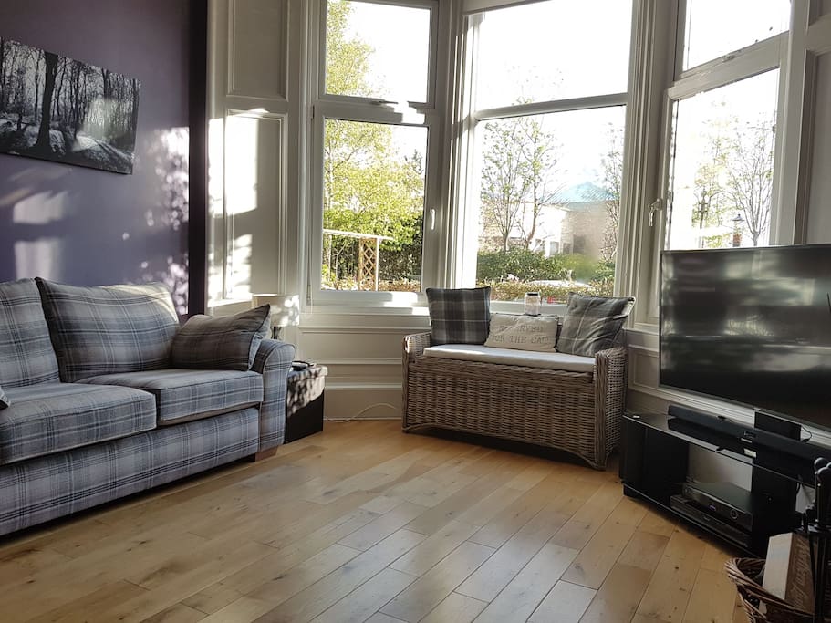 Front room with south facing sunny bay window