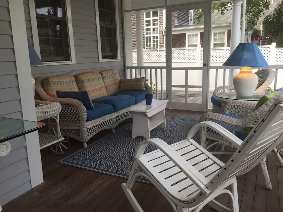 Screened porch sitting area is a wonderful retreat