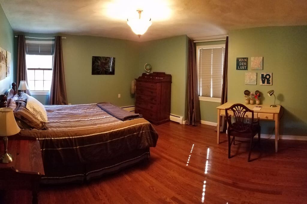 Bedroom with queen size bed, nightstand, dresser, desk, and closet