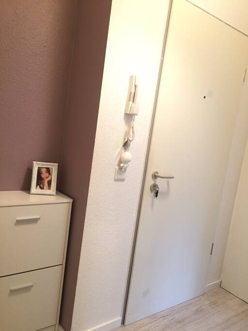 Wohnungstür von innen. Ein Schuhschrank (links) und ein eingebauter Schrank (rechts) für zusätzlichen Stauraum. (Apartment door from within. A shoe cupboard (on the left) and a usual cupboard (on the right) for additional storage space.)