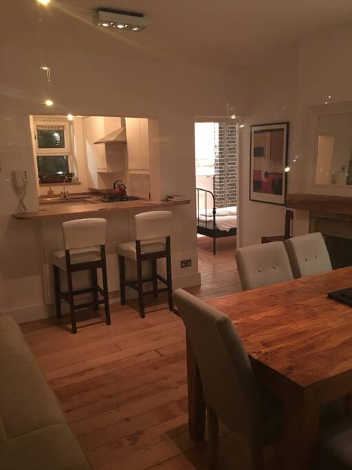 cozy and ample living area with kitchen and lounge connected with a breakfast bar