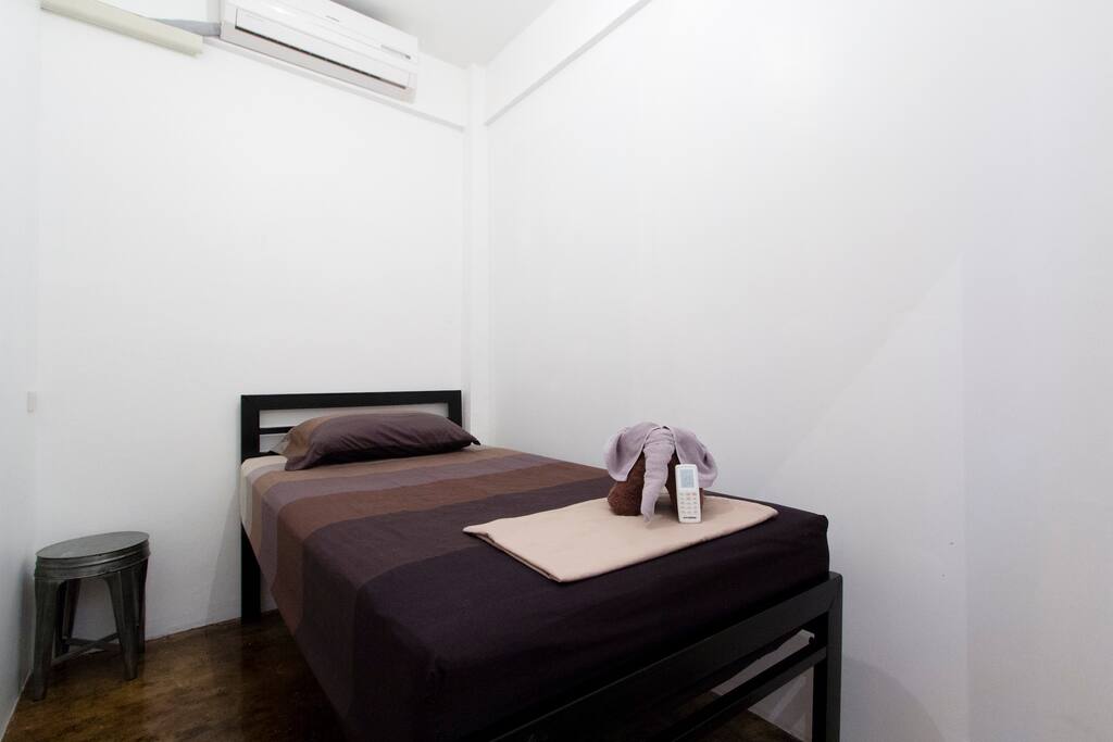 Your room! Your room comes with: 1 bed (high off the floor so your bag will easily fit underneath), 1 fitted sheet, 1 flat sheet, 1 shower towel, 1 hand towel, 1 a/c remote, 1 pillow, 1 throw pillow, 1 key for bedroom door, 1 plastic fob (blue/orange/red) for entrance door. If booked for 2 people, then 1 more shower towel. All rooms are basically the same size and shape and come with the same things just listed.