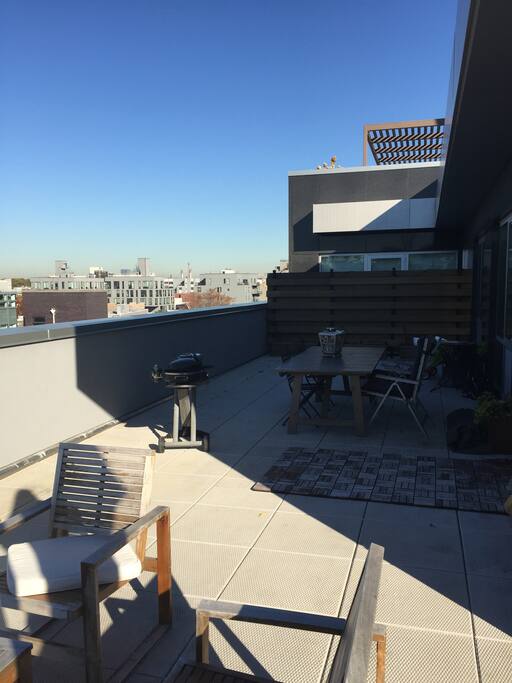 Table and Bbq grill on terrace.