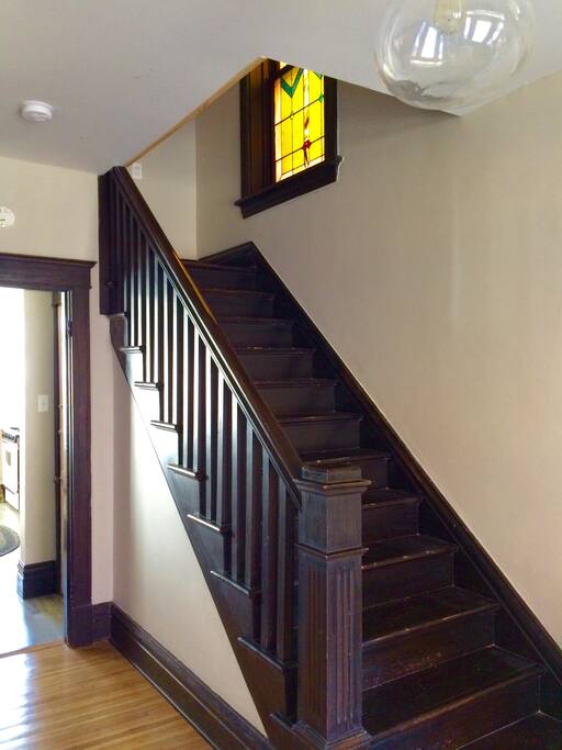 Original stair case & stained glass window.