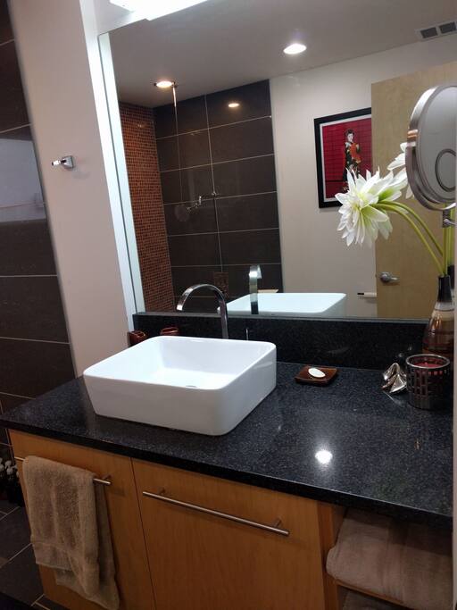 Bathroom 1 has tons of counter space, great light, and a convenient makeup mirror for all your primping needs!