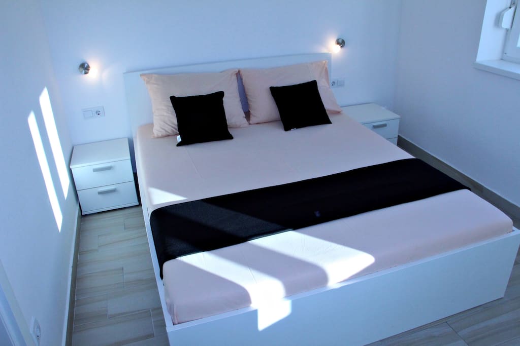 Bedroom with big comfortable double bed.