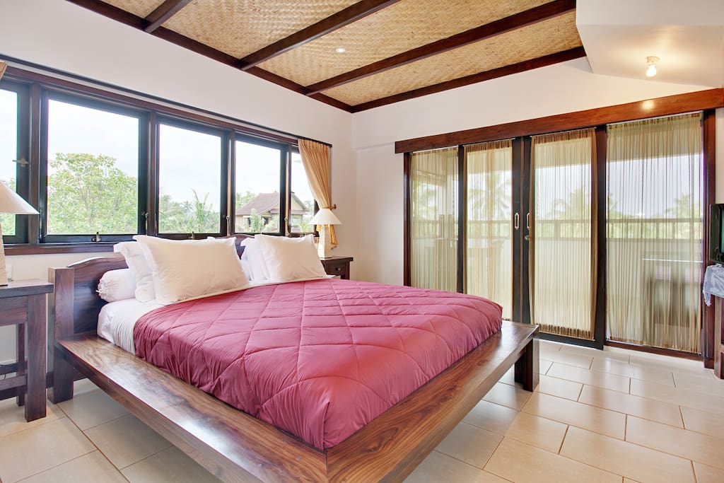 Open the new black out curtains ( not in this photo ) and expect to catch a few sunrises from the comfort of your entrance floor king room.. with private balcony, day bed table and chairs.