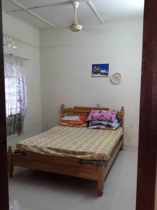 Master Bedroom with 1 Queen bed with 2 mattress and a cupboard.