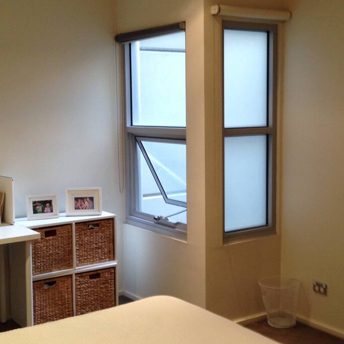 Desk with corner windows and roller blinds