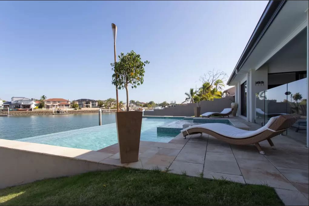 View of pool and canal from backyard