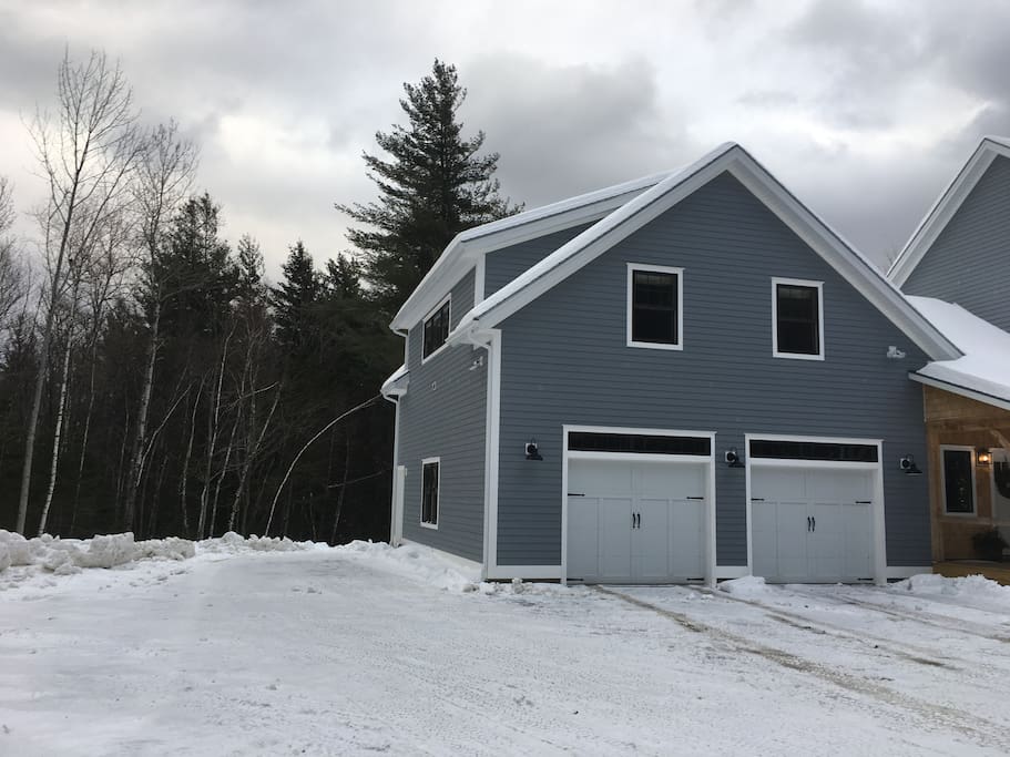 Private parking space and entrance to apartment on the left of garage.