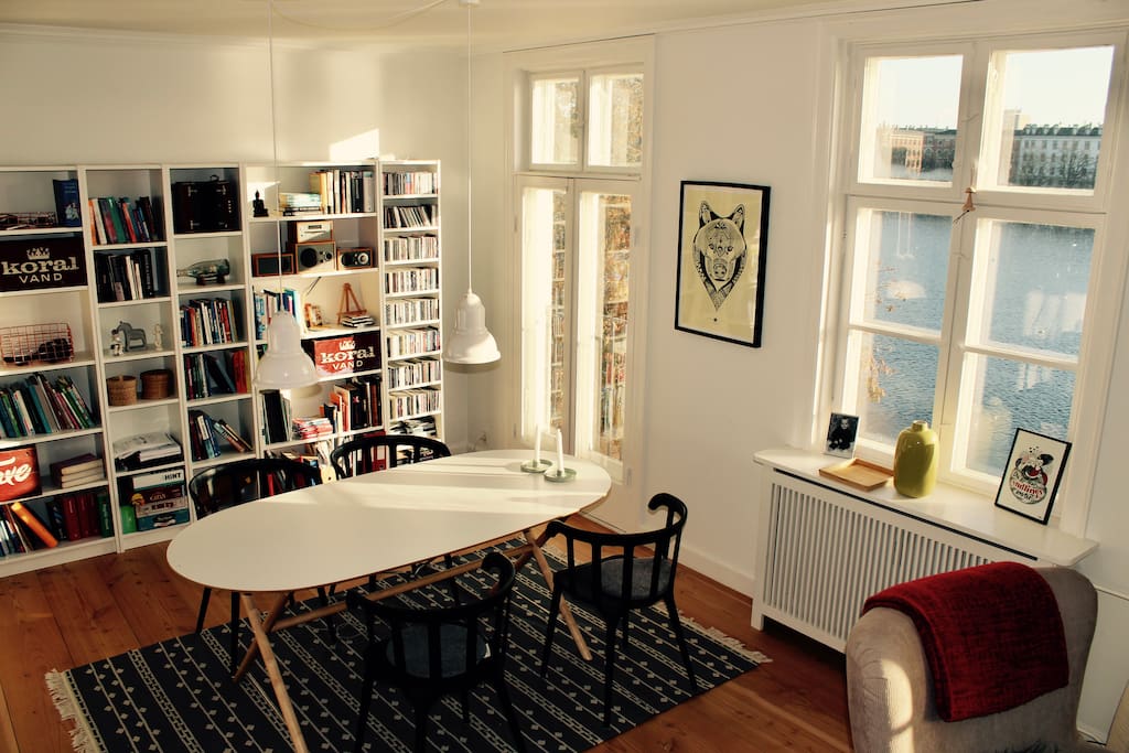 The living room is divided in two. At one end there is dining table and at the other end there is sofas and television.
