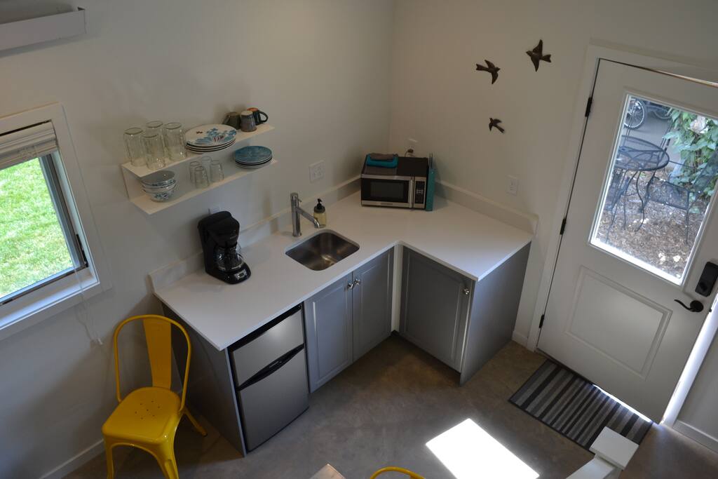 Stairs down to the entry landing looking at the kitchenette.