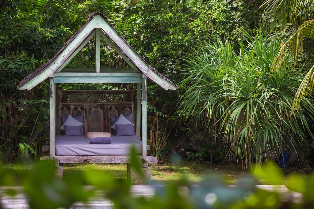 Lounging area beside swimming pool in garden