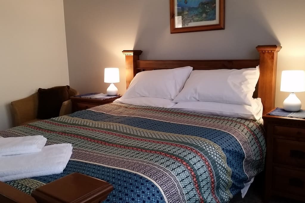 A view of the main bedroom taken from near the window.