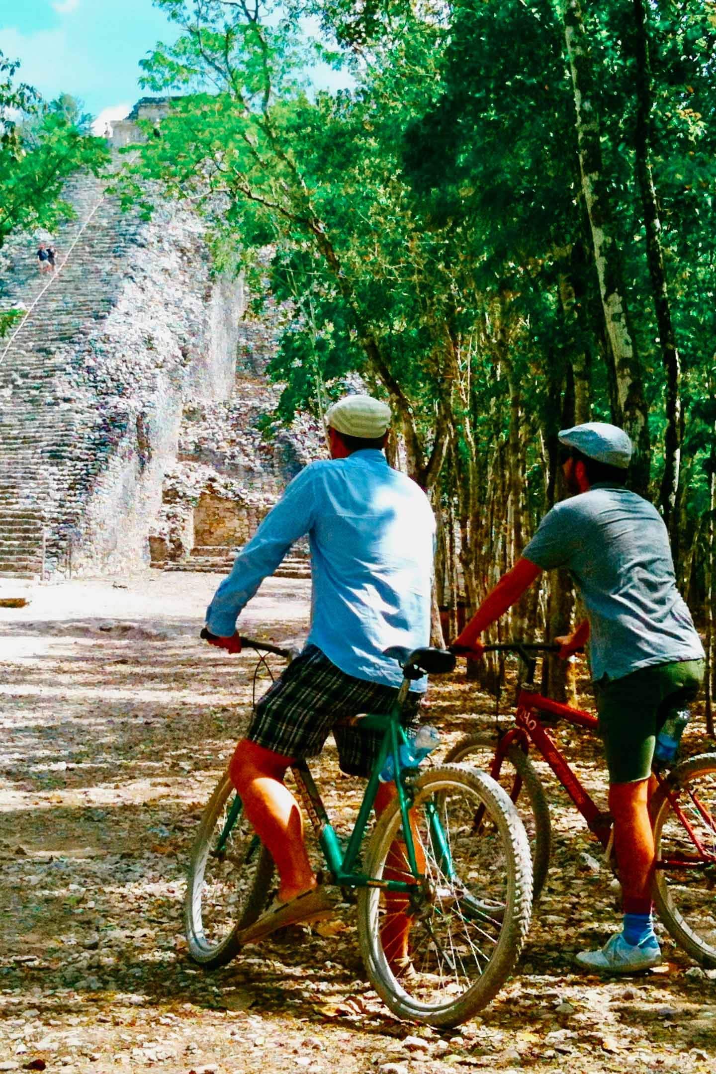 two men biking around Coba Pyramid