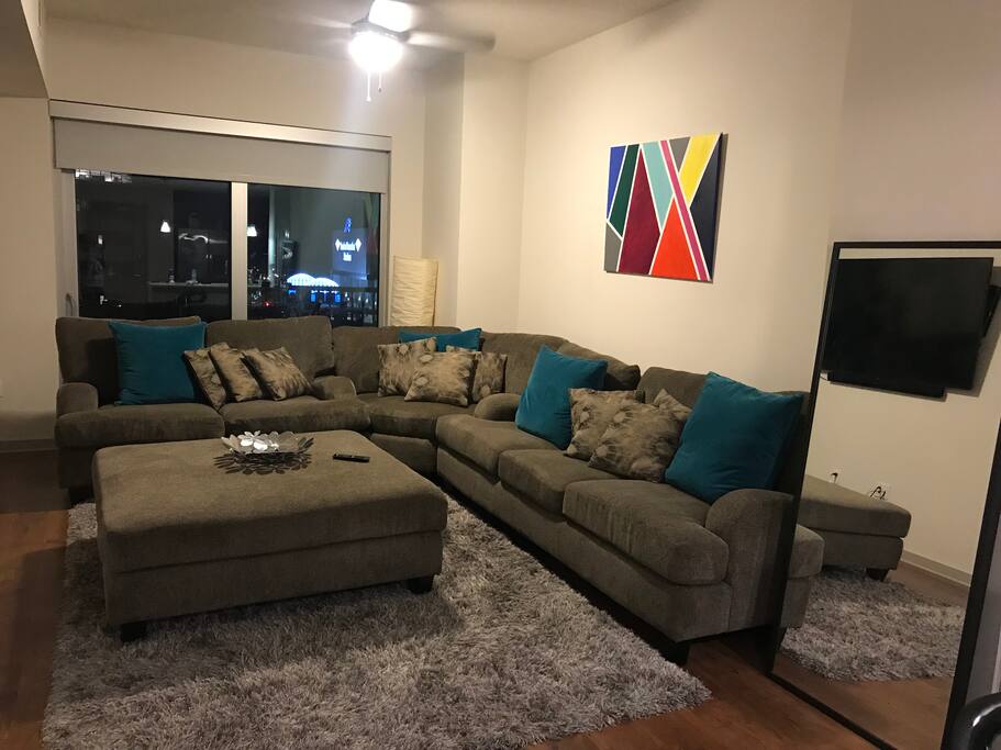 Living room wrap around couch very comfy and lounging to enjoy a great movie or game on “70 tv!
