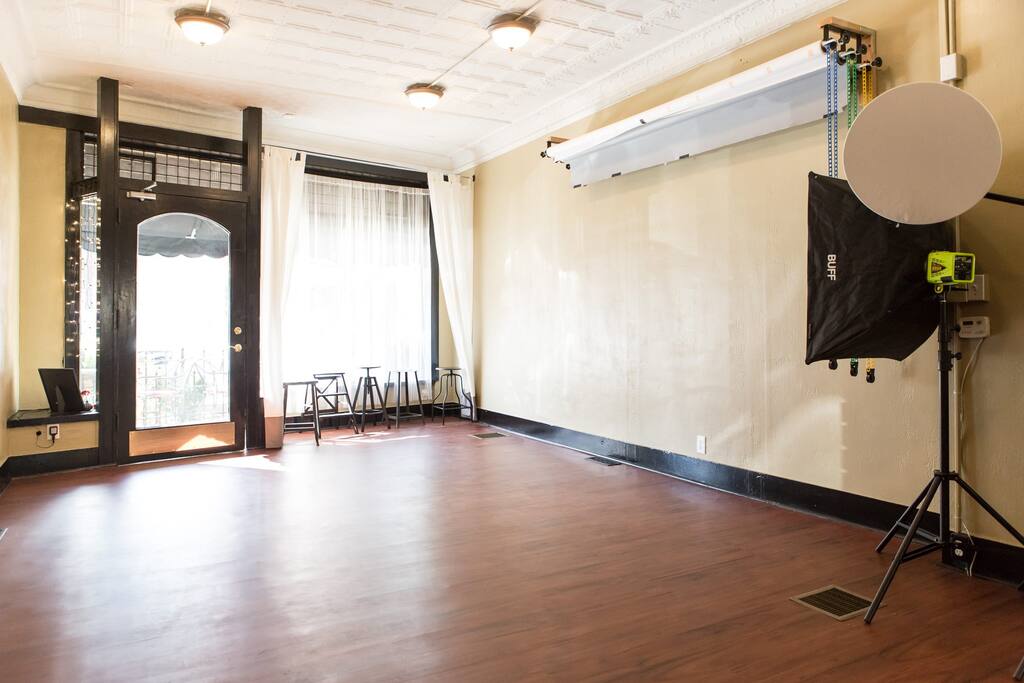 Large windows with sheer and cloth curtains to control natural light. Three seamless paper backdrops are available in white, gray, and mocha.