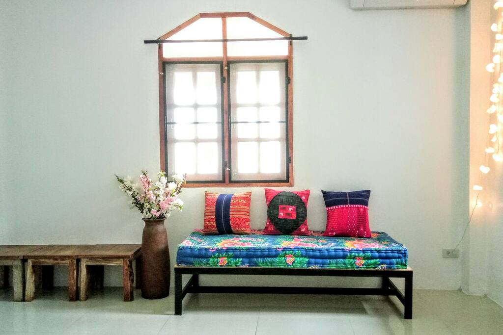 Another side of the living room with chairs and a daybed for relaxation and quality time.