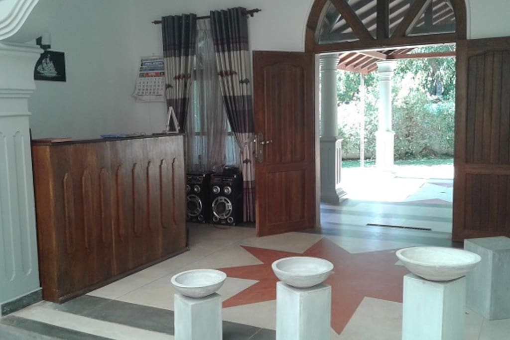 the reception desk looking out on to the porch through the two big entrance doors