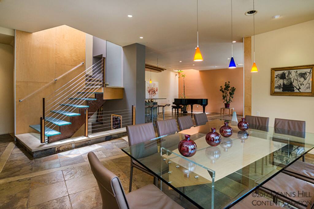 Main living room + main dining room area. Stairs to lower and upper level.