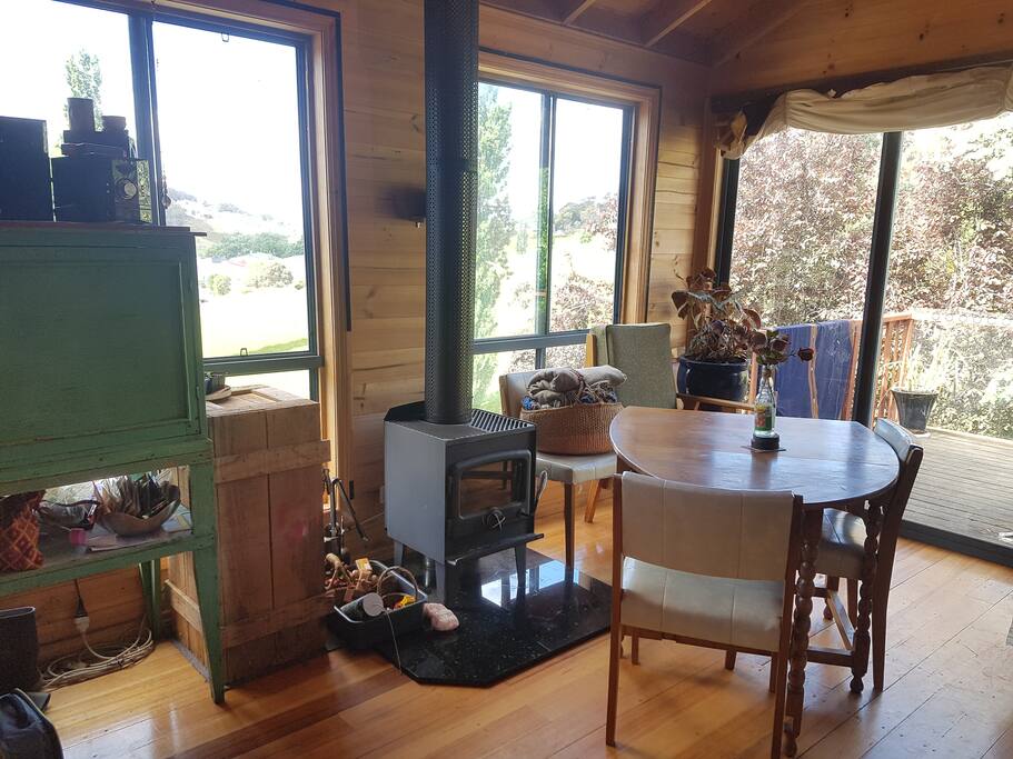 In the colder months, this super efficient nectre woodheater keeps the place toasty warm. And the hand crafted blackwood table folds out to seat up to 6 people.