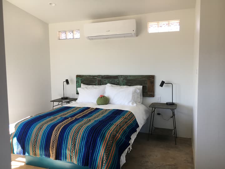 Enjoy a fresh, crisp interior. The bedroom features a queen sized bed and luxury linens with desert flair.