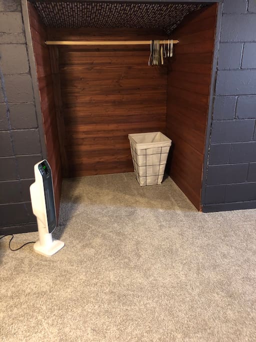 Cedar lined closet with hangers and hamper for dirty linens