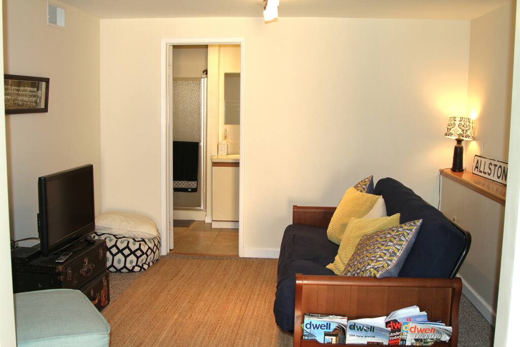 Living room with double-sized futon sofabed and attached bathroom