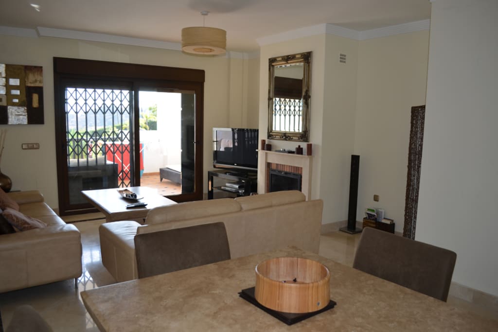 Large 3 seat sofa, 1 large double sofa and large dining table in main living area.